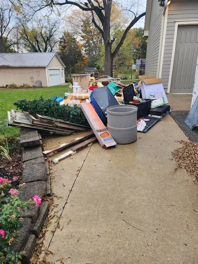 Dumpster being loaded with debris for Roofing Dumpster Rental in Potomac